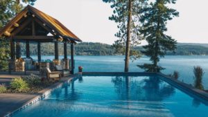 Lakeside infinity pool with scenic view