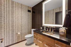 Modern bathroom with illuminated mirror.