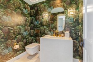 Stylish bathroom with nature-themed wallpaper