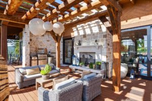 Rustic patio with pergola and outdoor kitchen.