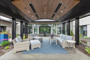 Modern outdoor patio with seating and plants.