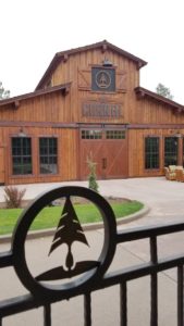 Rustic wooden barn with The Corral sign.