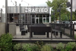 Outdoor patio of Crafted cafe with string lights.
