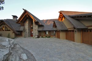 Modern mountain home with stone and wood exterior.