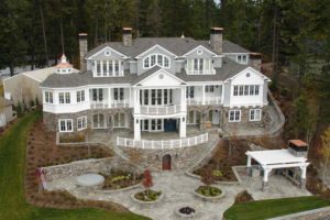 Elegant mansion with stone facade and lush garden.