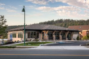 Ellenbecker Eye Clinic Eye clinic building with forest backdrop.