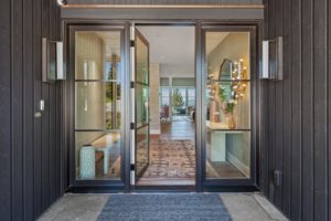 Modern glass door entrance to stylish home interior.