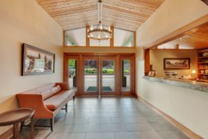 Hayden Lake Country Club Refresh Modern hotel lobby with wooden decor.