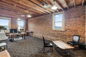 Rustic office with brick walls and natural light.