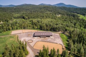 Aerial view of building in forest with mountains