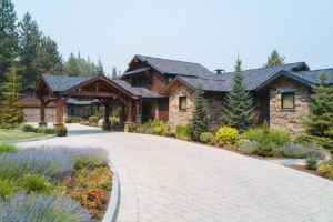 Modern rustic home with landscaped driveway