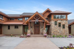 Harrison Residence #1 Rustic stone and wood house exterior with garden.
