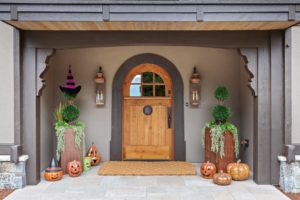 Hayden Lake Chalet Halloween porch decor with pumpkins and lanterns.