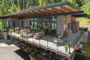 Modern lakeside cabin with spacious deck.