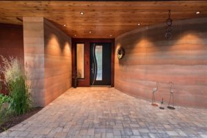 Lake Fernan Residence - Passive House Institute Certified Modern entryway with curved walls and stylish door.