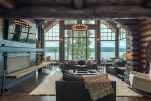 Rustic cabin living room with lake view.