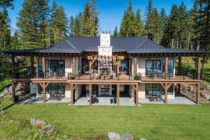 Luxury cabin with forest view and large deck.