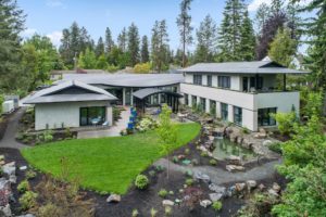 Modern home with garden and pond landscape.