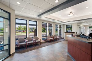 Ellenbecker Eye Clinic Modern waiting room with large windows and seating.