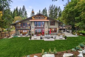 Hayden Lake Chalet Modern mountain home with lush backyard garden.