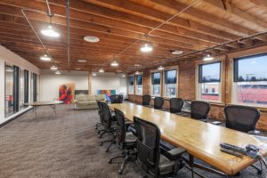 Modern office space with large conference table.
