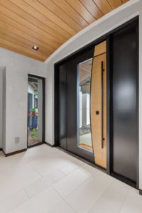 Modern wooden front door with sleek black accents