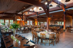 Rustic event hall with elegant table settings.