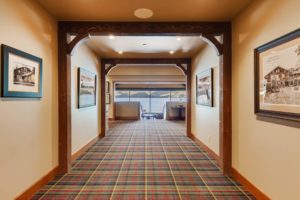 Hayden Lake Country Club Refresh Hotel hallway with lake view through windows.