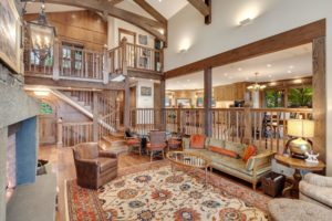 Hayden Lake Chalet Rustic living room with wooden beams and cozy decor.