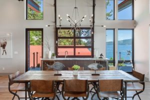 Modern dining room with lake view windows.