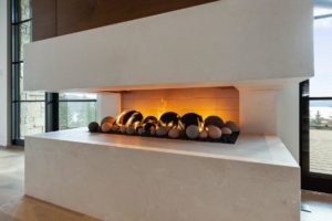 Modern fireplace with decorative stones.