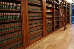 Library bookshelves with a wooden ladder.