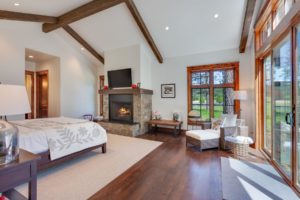 Cozy bedroom with fireplace and large windows