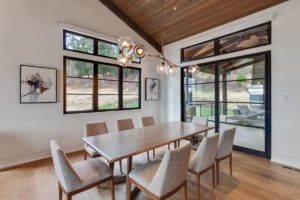 Modern dining room with stylish lighting fixture.