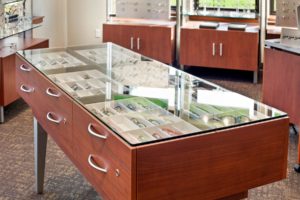 Ellenbecker Eye Clinic Optical store display with glasses in wooden cabinets.