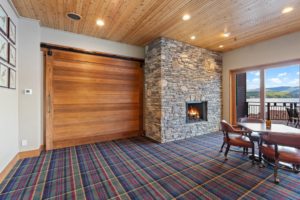 Hayden Lake Country Club Refresh Cozy room with fireplace and lake view balcony.