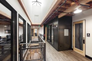 Modern office hallway with skylight ceiling.