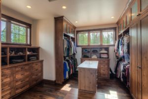 Harrison Residence #1 Spacious wooden walk-in closet with natural light.
