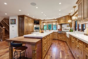 Hayden Lake Chalet Luxurious wooden kitchen with island and lighting
