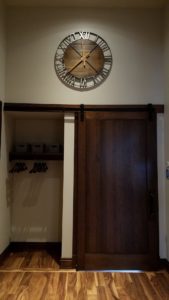 Rustic clock above sliding closet door