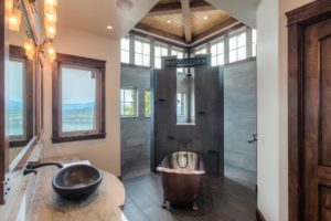 Harrison Residence #1 Luxury bathroom with tub and scenic view.