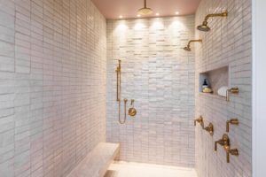 Luxurious shower with elegant gold fixtures.