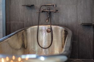 Harrison Residence #1 Luxurious metallic bathtub with vintage faucet.
