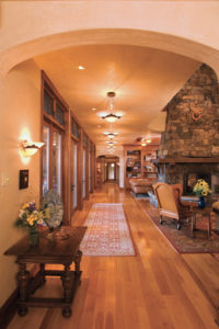 Cozy rustic living room with stone fireplace.