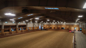 Indoor equestrian arena with ample lighting