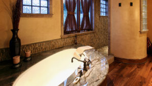 Luxurious bathroom with marble and warm lighting.