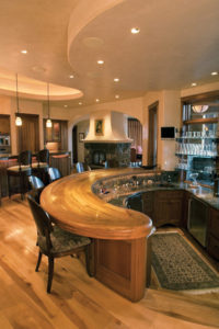 Luxury home bar with wooden countertop.