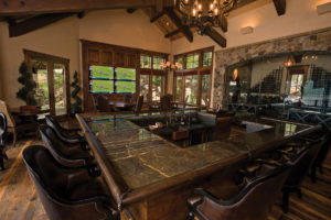 Luxury home bar interior with TV and wine storage.