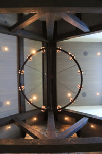 Rustic chandelier on wooden ceiling beams