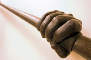 Bronze hand sculpture gripping rail